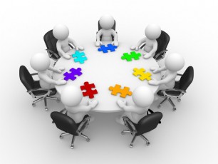 figures at a round table-colorful puzzle pieces