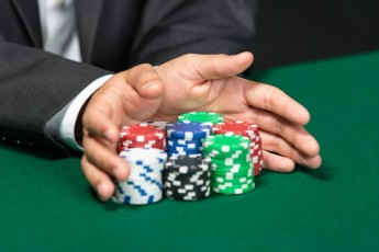 hands pushing poker chips