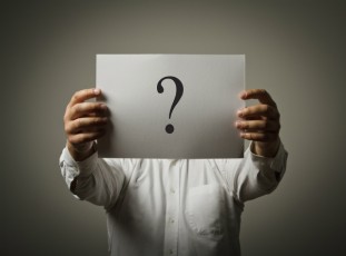 man holding question mark sign
