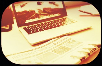 image laptop-beside-newspaper