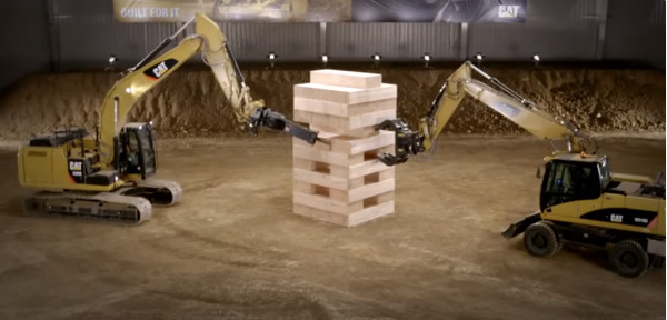 giant earth-movers playing jenga