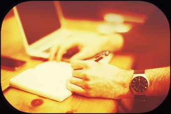 hand with pen-writing pad-laptop