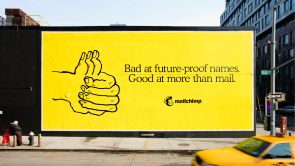 Image by Mailchimp that shows a billboard using the color yellow to stand out from the crowd.