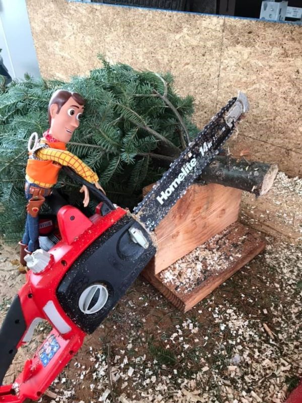 Image showing Toy Story’s Woody operating a chain saw in a Home Depot Store.