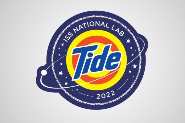 Image showing the ISS National Lab Nasa Tide logo. The first-ever astronaut laundry solution.