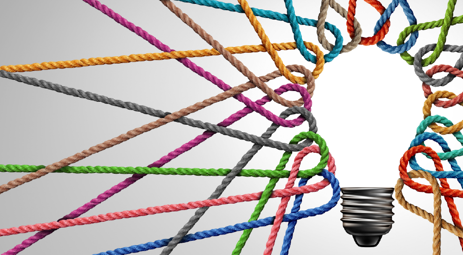 A lightbulb surrounded by multicolored ropes to represent the concept of responsible marketing.
