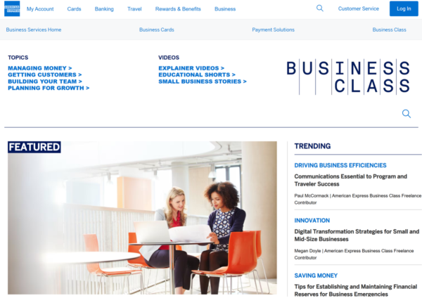 The American Express Business Class home page features two women sitting at a desk studying a document.