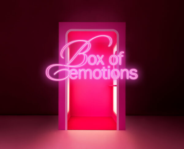 The pink and red Sokos Box of Emotions fitting room for trying on beauty products glows against a dark background.